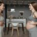 Two women indoors sharing a healthy fitness routine during pregnancy, promoting wellness.
